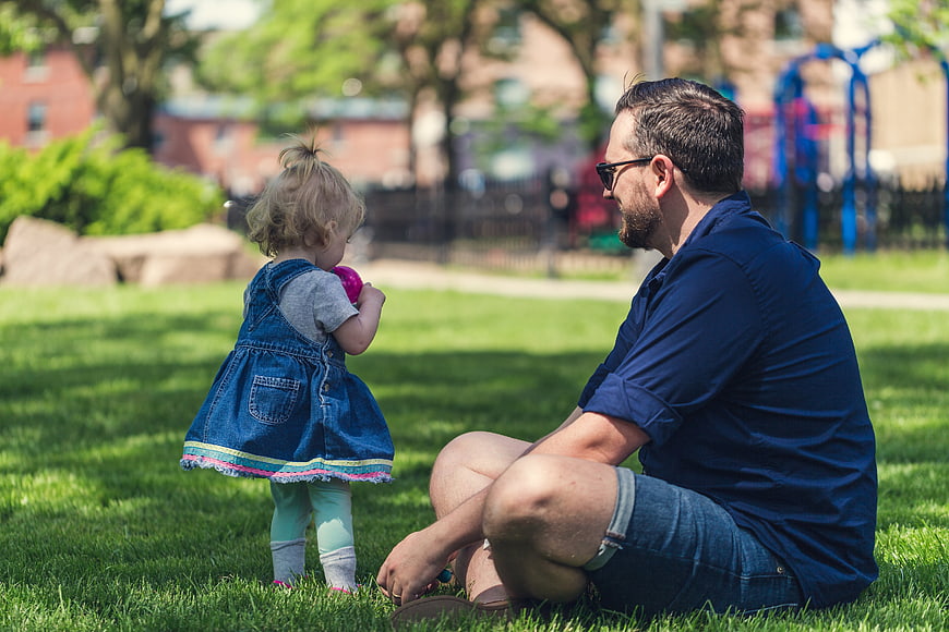 Father and Toddler Daughter Playing in Park