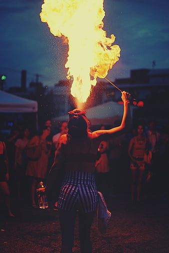 Woman Fire Breathing Performance at Night Festival