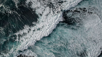 Aerial View of Turbulent Ocean Waves and White Sea Foam