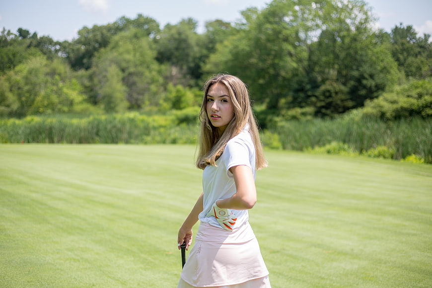 Young Female Golfer on Green Course