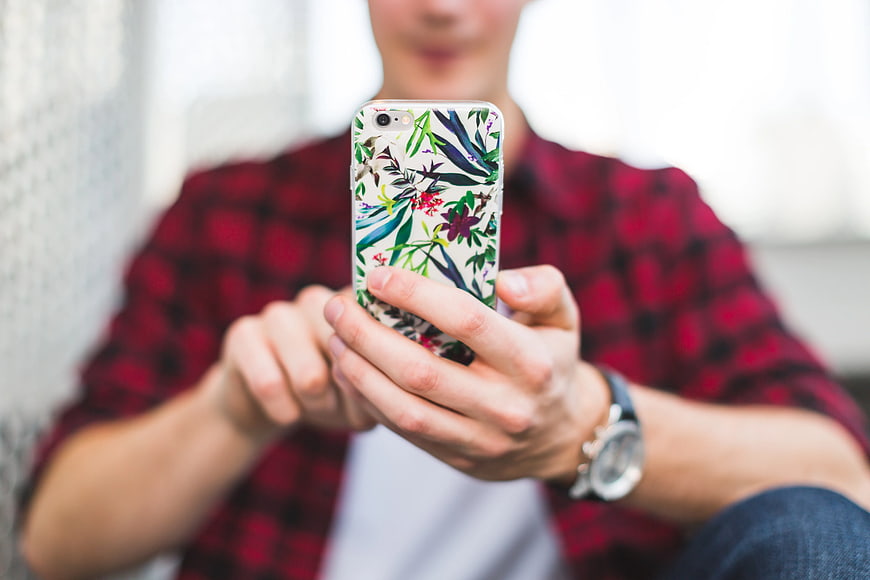 Man Holding Smartphone with Floral Case