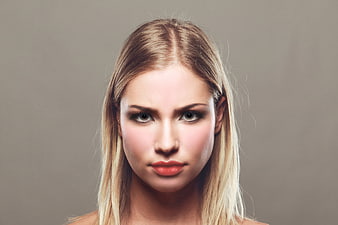 Studio Portrait Of A Blonde Woman With Dramatic Eye Makeup