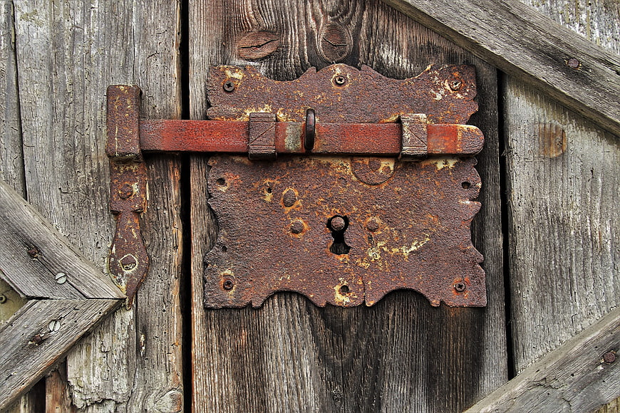Rusty Iron Latch on Weathered Wooden Barn Door