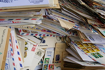 Stacks of vintage international letters and postage stamps
