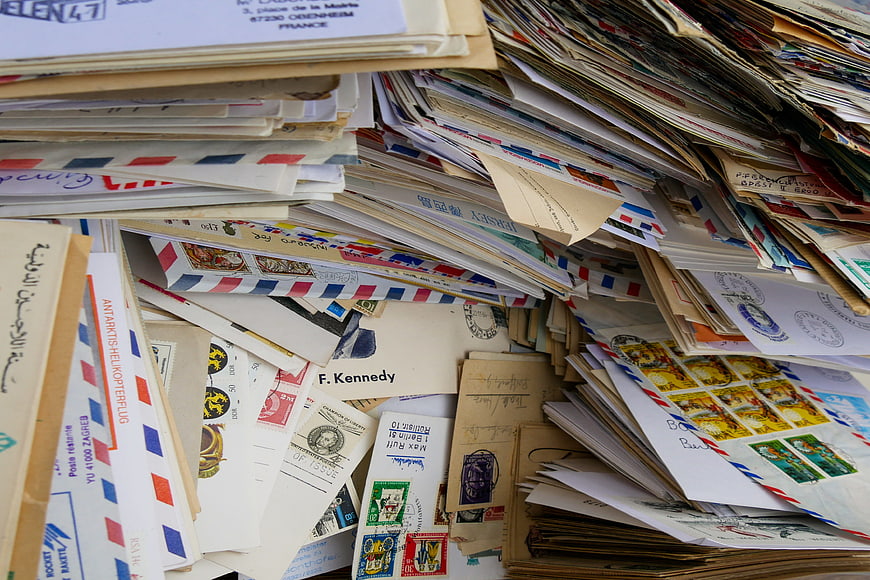 Stacks of vintage international letters and postage stamps