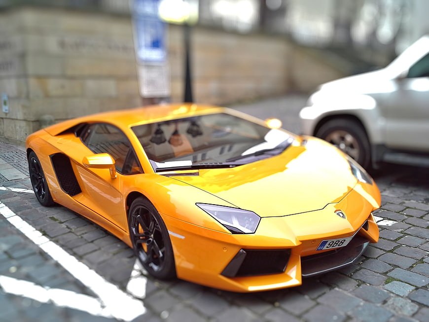 Orange Lamborghini Model Car on Cobblestone Street