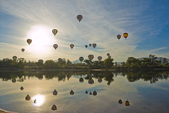 Hot Air Balloons Floating Over Lake at Sunrise
