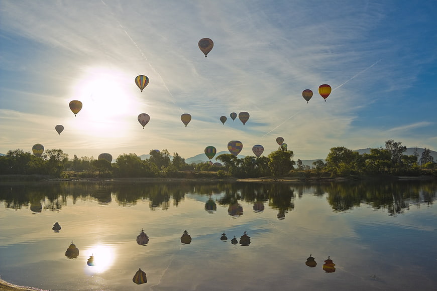 Hot Air Balloons Floating Over Lake at Sunrise