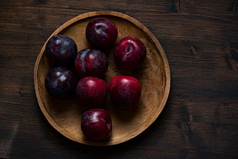 Fresh Red Plums in Wooden Bowl on Dark Table