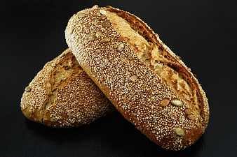 Freshly Baked Whole Wheat Bread with Seeds on Black Background