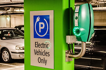 Green Electric Vehicle Charging Station in Parking Garage