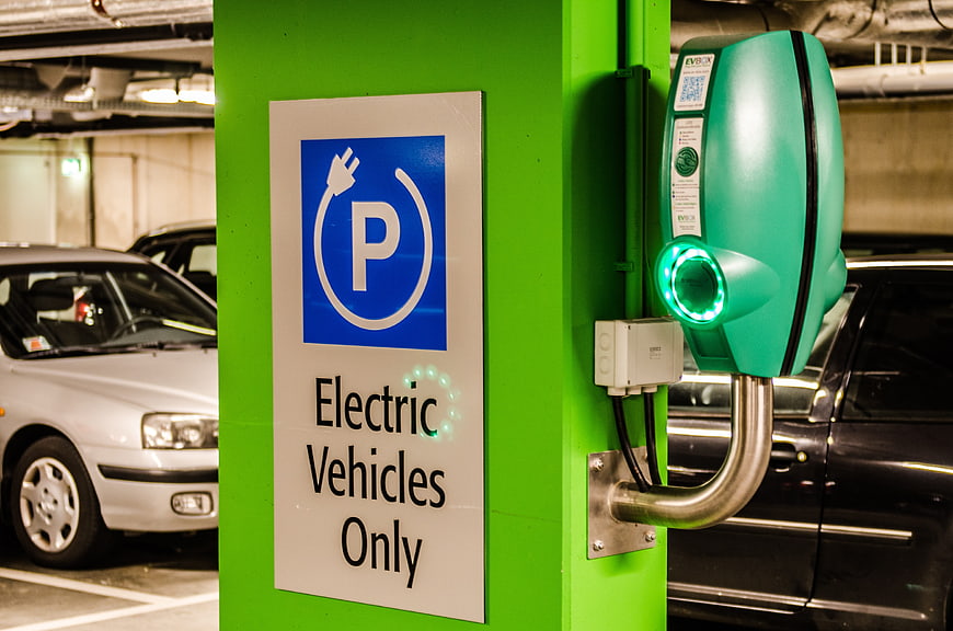 Green Electric Vehicle Charging Station in Parking Garage