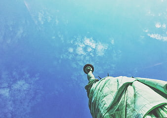 Low Angle View of Statue of Liberty Torch Against Blue Sky