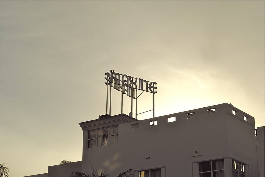 Vintage Maxine Theater Sign Silhouette Against Sepia Sky