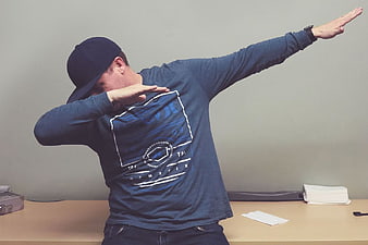 Man in Blue Shirt and Cap Doing the Dab Dance Move