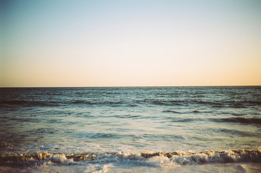 Serene Ocean Waves at Sunset with Vintage Film Grain
