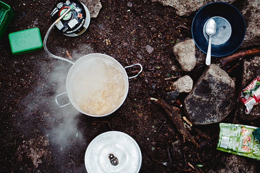 Top view of camping stove boiling water outdoors