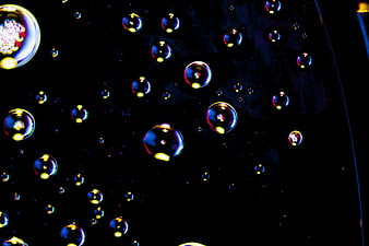 Macro photography of colorful oil bubbles on black background