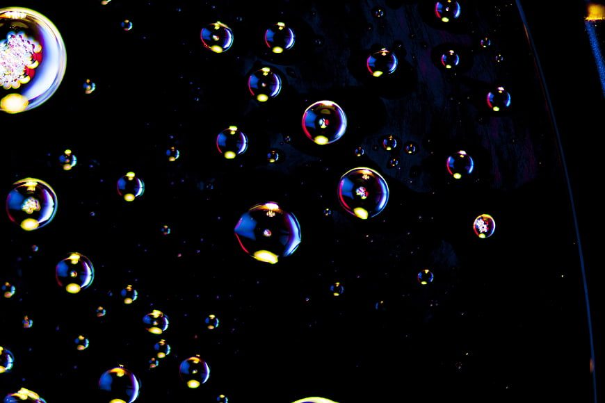 Macro photography of colorful oil bubbles on black background
