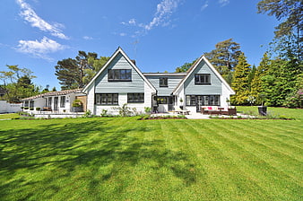 Modern Scandinavian House with Large Green Lawn and Blue Sky