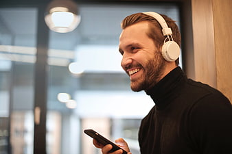 Happy Bearded Man Listening to Music with Headphones