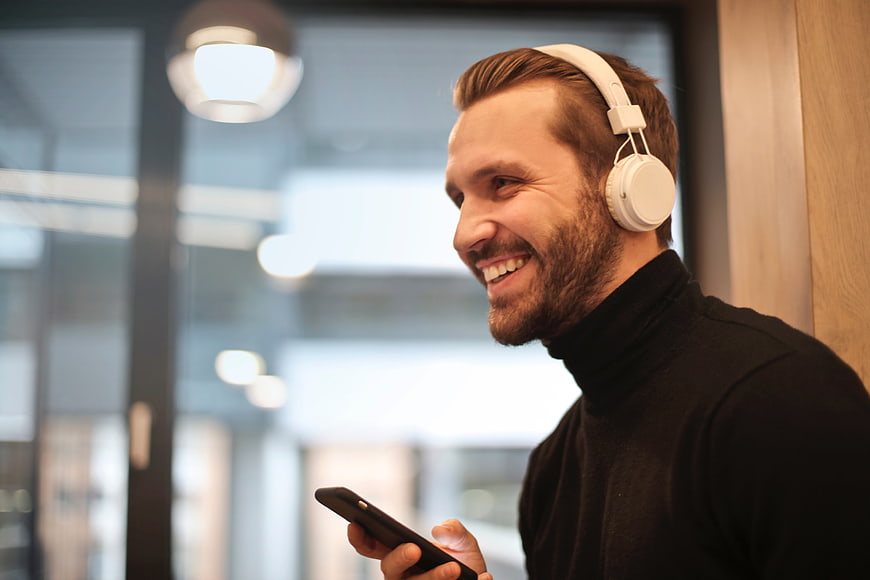 Happy Bearded Man Listening to Music with Headphones