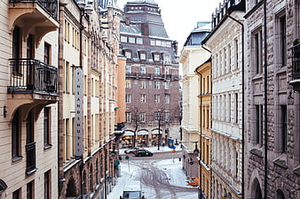 Snowy European Street with Historic Architecture and Finlandshuset Sign