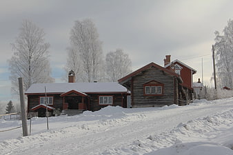 Traditional wooden houses in snowy winter landscape