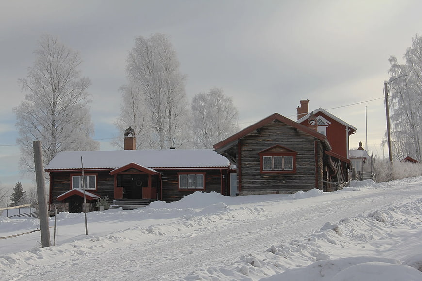 Traditional wooden houses in snowy winter landscape
