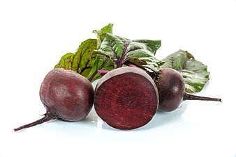 Fresh raw beetroots with green leaves on white background