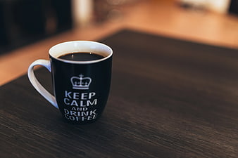 Black Coffee Mug with Keep Calm Text on Wooden Table