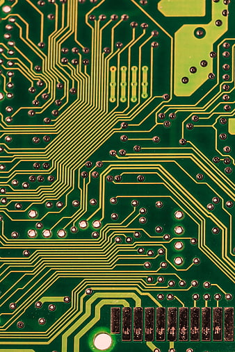 Macro shot of green printed circuit board with gold traces