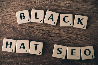 Black Hat SEO Concept with Scrabble Tiles on Wood