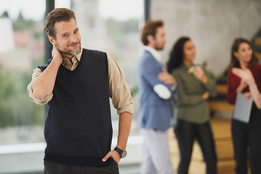 Confident Businessman Smiling in Modern Office