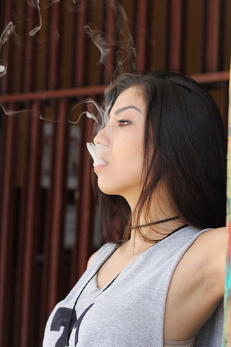 Young Woman Smoking with Smoke Rings