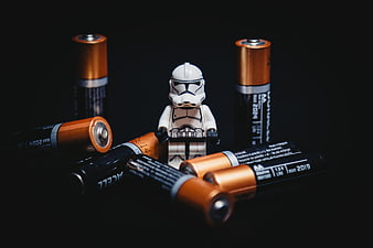 Lego Stormtrooper surrounded by AA batteries on black background