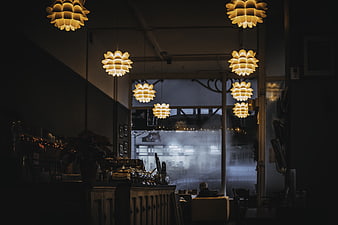Cozy Cafe Interior with Hanging Pendant Lights and Espresso Machine