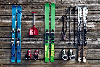 Flat lay of ski equipment on wooden deck