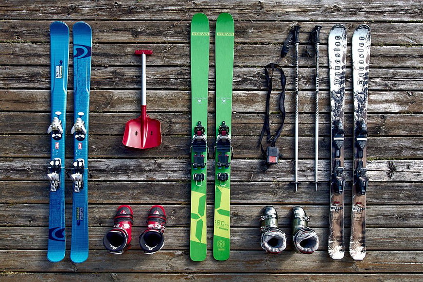 Flat lay of ski equipment on wooden deck