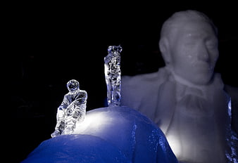 Ice sculptures with blue lighting and dark background