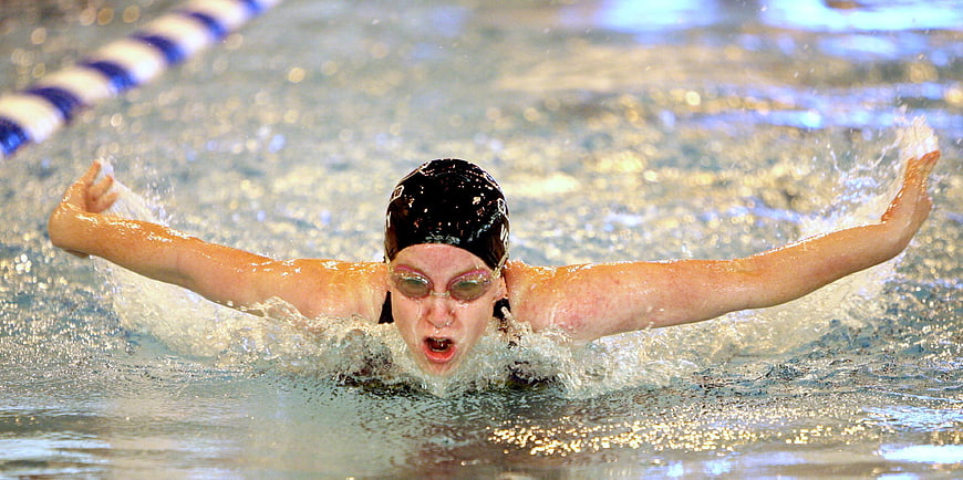 Female Swimmer Performing Butterfly Stroke in Pool