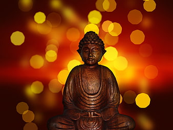 Wooden Buddha Statue with Golden Bokeh Background