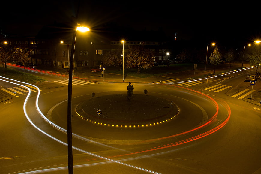Nighttime Roundabout Long Exposure with Light Trails and Pedestrian