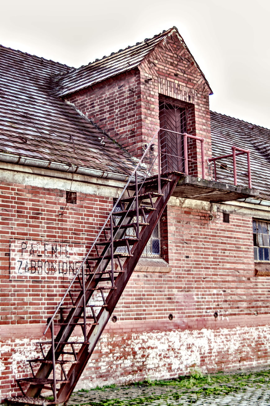 Rusty metal stairs on abandoned red brick industrial building