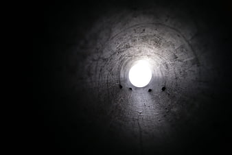 Dark Concrete Tunnel With Bright Light At The End