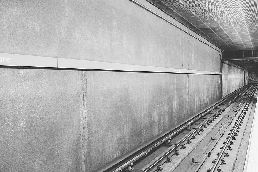 Empty subway tracks in a concrete tunnel station