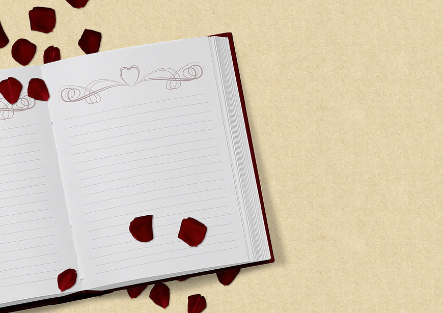 Open Notebook with Red Rose Petals on Beige Background