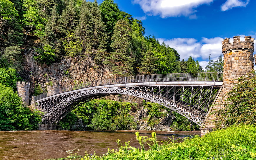 Iron Arch Bridge Spanning River in Lush Forest
