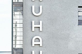 Vertical Bauhaus Sign on Modern Concrete Building Facade
