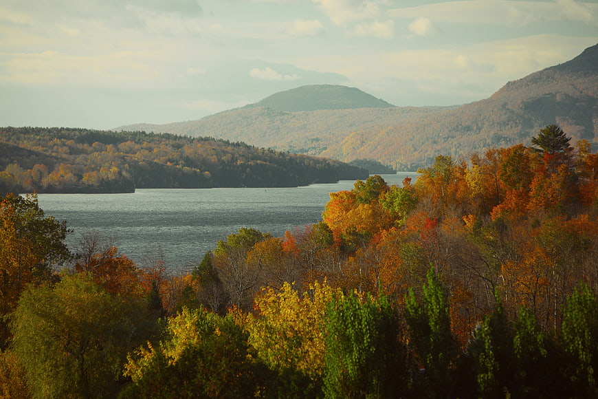 Scenic autumn landscape with lake, mountains, and colorful foliage